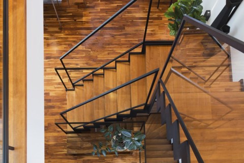 Top view of black powder coated steel L-shaped staircase with stained and varnished wooden steps