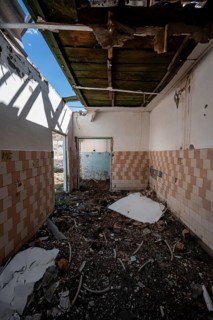 Destroyed abandoned room with tiles full of rubble, ghost town, Engilchek, Tian Shan, Kyrgyzstan,