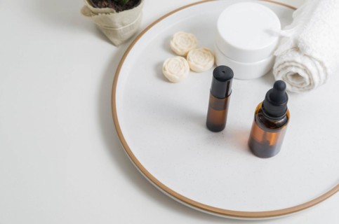 Cosmetic packaging. Set of different cosmetics on plate with decoration. Skin care concept
