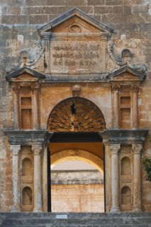 Stone steps and arched entrance with Doric columns at Holy Trinity (Agia Triada) Monastery,
