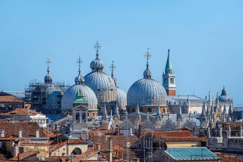 View over the rooftops of Venice to the domes of St Mark's Basilica, view from the roof of the
