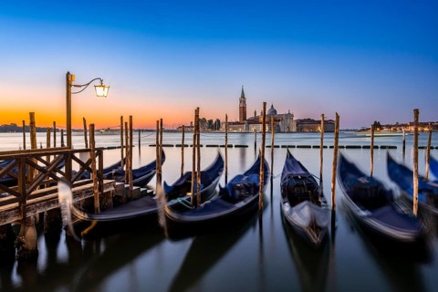 Venetian gondolas, boat dock at St Mark's Square, church of San Giorgio Maggiore in the background,