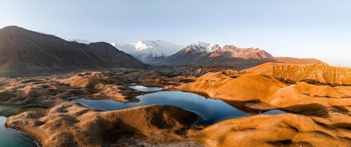 Aerial view, high mountain landscape with glacial moraines and mountain lakes, behind Pik Lenin,