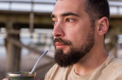 Man drinking chimarrao, mate tea tea (an infusion of yerba mate tea tea with hot water) at sunset