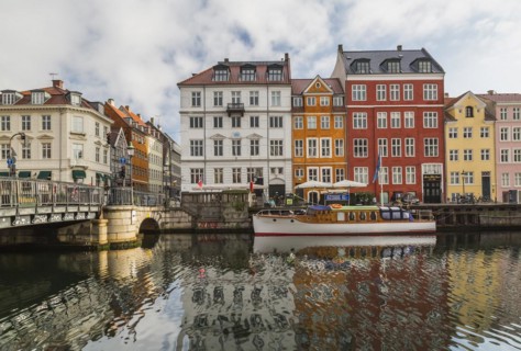Canal bridge with moored boat and colourful 17th century apartment buildings and houses along the