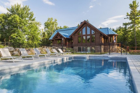 In-ground salt water swimming pool and brown stained milled Eastern white pine timber and flat log