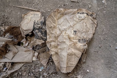 Remains of an old Kyrgyz newspaper from 1924 with Cyrillic writing in an abandoned building, ghost