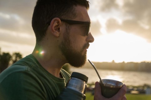 Man drinking chimarrao, mate tea tea (an infusion of yerba mate tea tea with hot water) at sunset