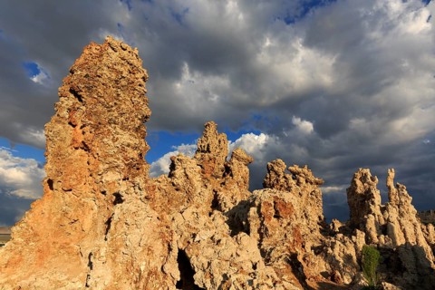 Sunlit tufa rocks against dark clouds, near the golden hour, Mono Lake, North America, USA,