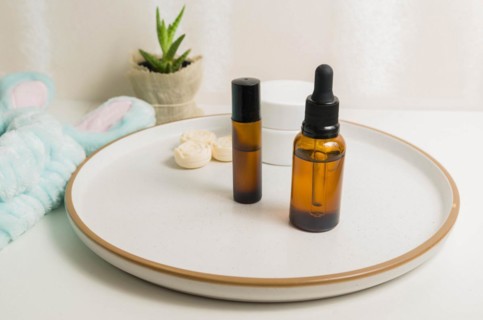 Cosmetic packaging. Set of different cosmetics on plate with decoration. Skin care concept