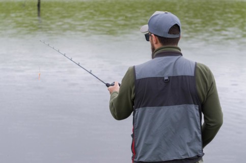 Black bass fisherman fishing inside lake, Cambara do sul, Rio Grande do sul, Brazil, South America