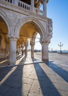 Colonnade of the Doge's Palace with Sun Star in the Piazetta San Marco, St Mark's Square, Venice,