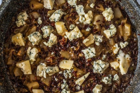 Closeup top view of frying pan with risotto with pear and blue cheese