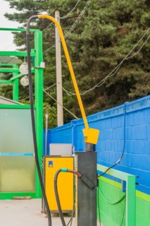 Side view of vacuum cleaner with hose attached with green duct tape at gas station car wash in