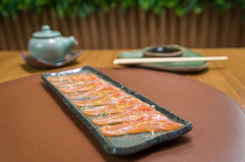 Delicious premium salmon sashimi arranged on an elegant handmade platter