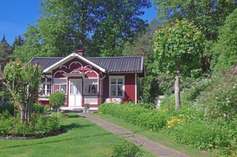 Small red wooden house in a garden, lock keeper's house, waterway, Dalsland Canal, Dalsland,