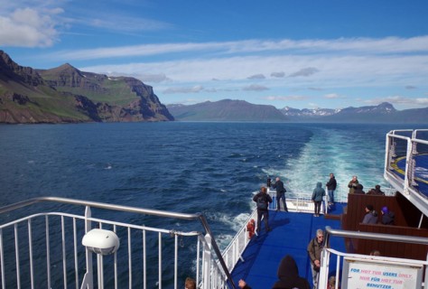 People queuing at the railing of the car ferry Noerroena at the entrance to a fjord, ferry between