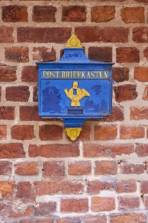 Old blue post box on a brick facade in Boettcherstrasse in Bremen, Hanseatic city, state of Bremen,