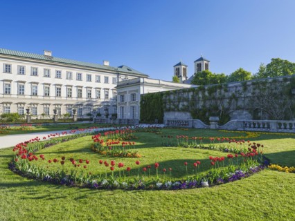 Mirabelle plum palace with flowers in the foreground, Mirabelle gardens, blue sky, Salzburg,
