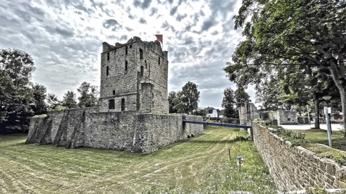 Photo in style of old historical postcard of ruins of former moated castle with in the centre
