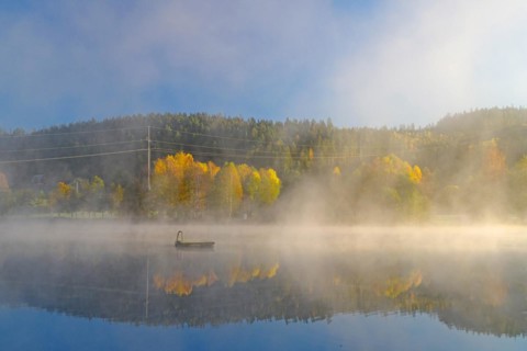 Sunrise and autumn morning mist over a calm lake, bathing island, foliage colouring, Bullaren,