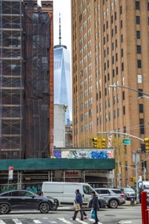 The One World Trade Centre can be seen at the end of a street canyon, Lower Manhattan, New York