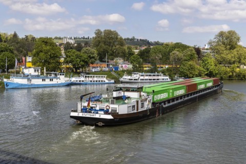 Container ship travelling on the Neckar, in the background the Wilhelma landing stage, excursion
