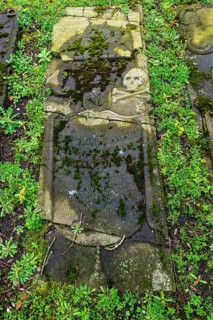 Weathered historical gravestone in the churchyard, Protestant Reformed St George's Church in the