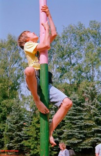 Boy climbs on maypole, barefoot, Heiligenthal, Lower Saxony, Germany, 20/06/1992, vintage, retro,