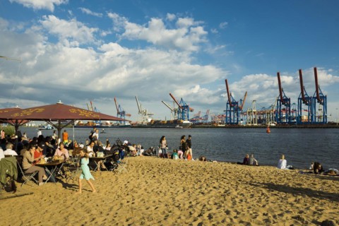 People on the beach, Strandbar Strandperle, Elbe beach, Hamburg harbour in the background,