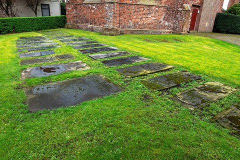 Weathered historical gravestones in the churchyard, Protestant Reformed St George's Church in the
