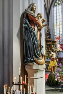 Figure of the Virgin Mary with baby Jesus and sacrificial candles, St Martin's Church, Kaufbeuern,