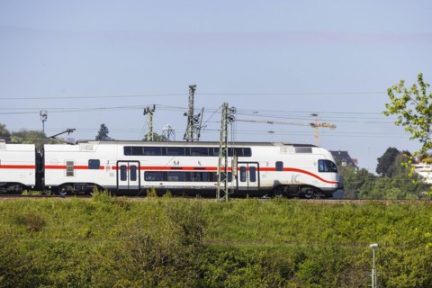 Deutsche Bahn AG InterCity en route, railway embankment and overhead lines, infrastructure,