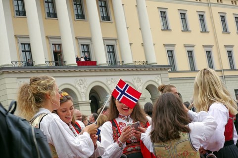 Several young ladies in old traditional costumes with national flags, The royal family on the
