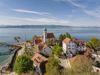 Moated castle peninsula with castle and parish church of St George on Lake Constance. Aerial view,