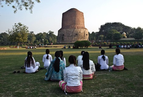 Buddhist young women from South east Asia, meditation in a buddhist pilgrimage site, Sarnath stupa,