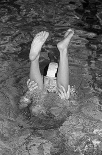 Boy looking through legs of another boy doing handstand, indoor swimming pool, Bamberg, Upper