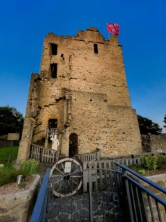 Photo at dusk of historic ruins of Romanesque residential tower of former moated castle from 12th