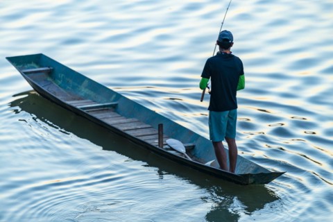 Fisherman with boat on the Mekong, Luang Prabang, Laos, Asia