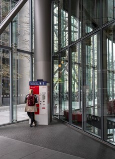 Woman standing at a Deutsche Bahn ticket machine, Berlin, Germany, Europe