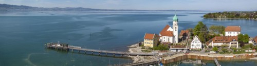 Moated castle peninsula with castle and parish church of St George on Lake Constance. Aerial photo,