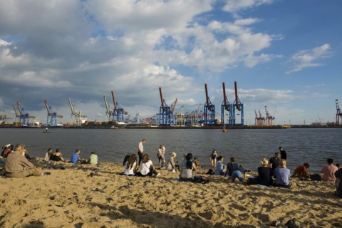People on the beach, Strandbar Strandperle, Elbe beach, Hamburg harbour in the background,