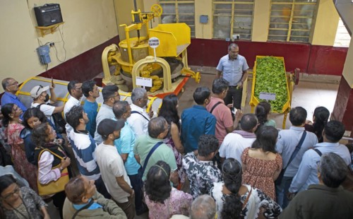 Indian visitors at a demonstration in the Munnar Tea Museum, Munnar, Kerala, India, Asia