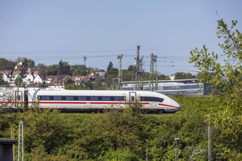 Deutsche Bahn AG InterCityExpress ICE en route, railway embankment and overhead lines,