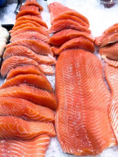 Display of Pacific salmon (Oncorhynchus) caught by fishing in the form of salmon fillet on ice in