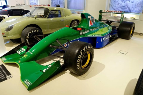 JORDAN 191 F1 MICHAEL SCHUHMACHER, A green Jordan Formula 1 racing car with sponsors in a showroom,