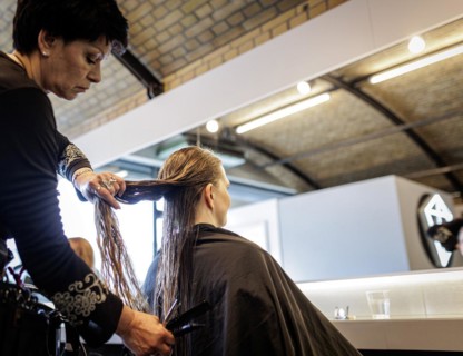Valentyna Vysotska, hairdresser from Ukraine, combs her customer's hair, taken at the hairdressing