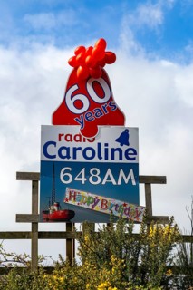 Radio Caroline pirate radio station 60 years old happy birthday balloons and poster, Suffolk,