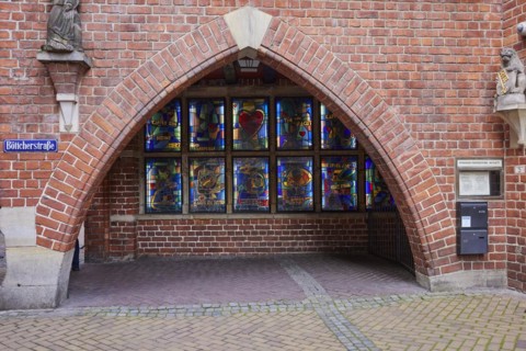 Brick building with arch and illuminated colourful windows in Boettcherstrasse, Bremen, Hanseatic