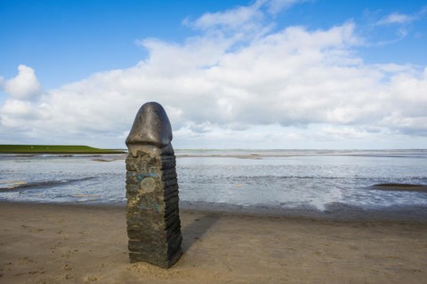 Stone sculpture on the beach and Wadden Sea, penis, artist Eckart Grenzer, Dangast, Jade Bay, North